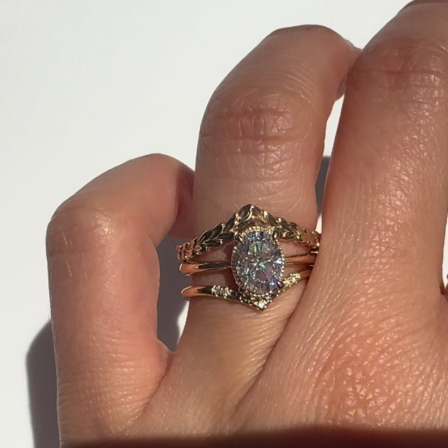 The Hera Ring features a 1ct. oval diamond or moissanite set in a delicately milgrained setting. This elegant and romantic design effortlessly blends old-world charm with a modern aesthetic. It’s the perfect choice for engagements, milestone celebrations, birthdays, and anniversaries, making it a timeless piece.