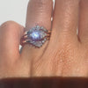 three diamond rings stacked together on a hand against a white background